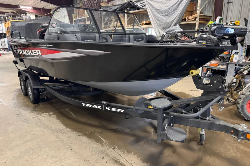 Slide: The Image of 2026 Tracker Targa V-19 Combo boat on trailer in a warehouse setting. - 2