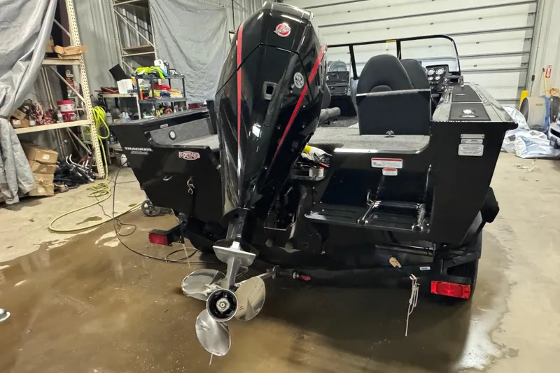 Slide: The Image of 2026 Tracker Targa V-19 Combo boat in garage, showcasing powerful outboard motor. - 3