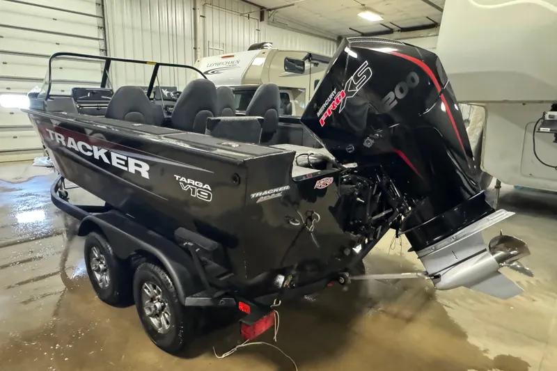 Slide: The Image of 2026 Tracker Targa V-19 Combo boat with Mercury 200 engine in a garage. - 4