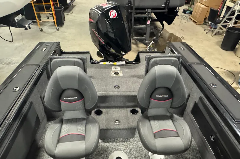 Slide: The Image of 2026 Tracker Targa V-19 Combo boat interior with dual gray seats and outboard motor. - 9