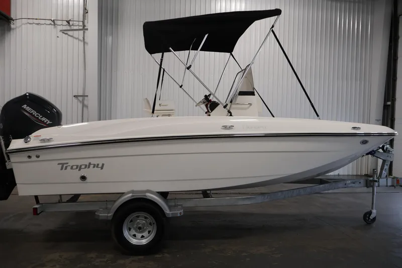 Slide: The Image of 2026 Bayliner Trophy T18 boat on trailer in indoor storage. - 13