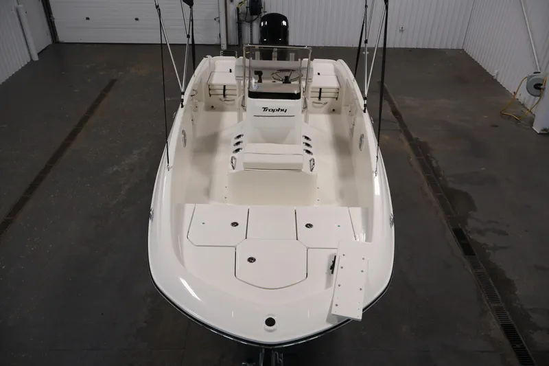 Slide: The Image of 2026 Bayliner Trophy T18 boat in a spacious indoor setting, showcasing its sleek design. - 15