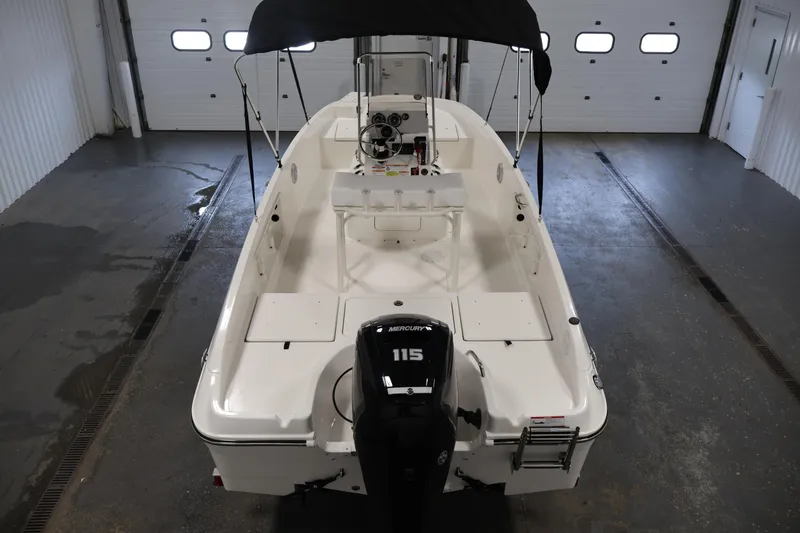 Slide: The Image of 2026 Bayliner Trophy T18 boat with Mercury 115 engine in a garage setting. - 16