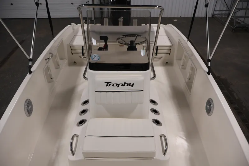 Slide: The Image of 2026 Bayliner Trophy T18 boat interior with steering console and seating. - 22