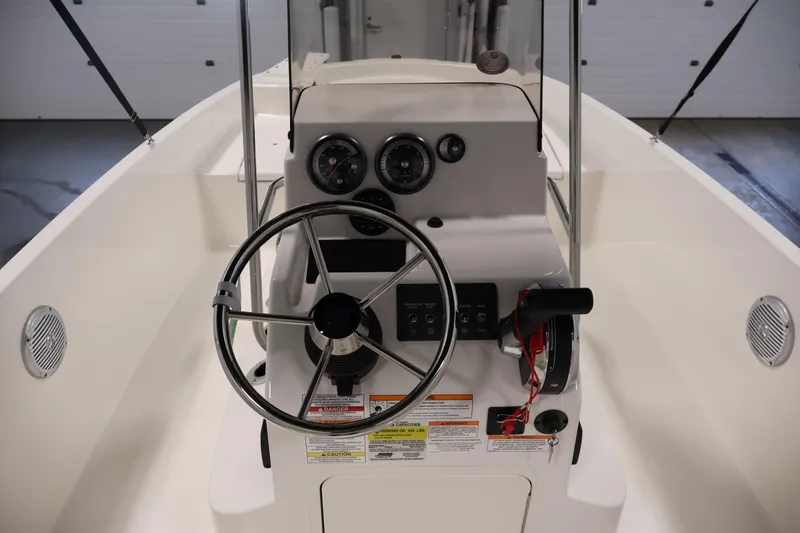 Slide: The Image of 2026 Bayliner Trophy T18 boat helm with steering wheel and control panel. - 26