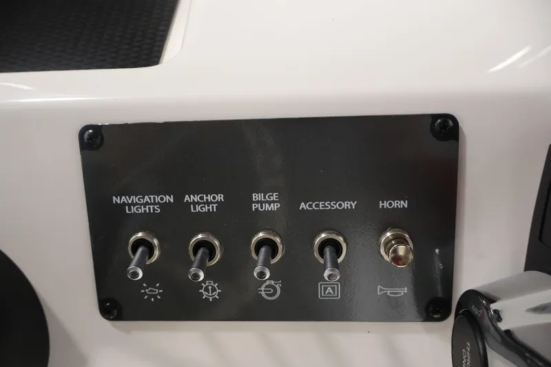 Slide: The Image of Control panel of 2026 Bayliner Trophy T18 boat with switches for lights, pump, and horn. - 29