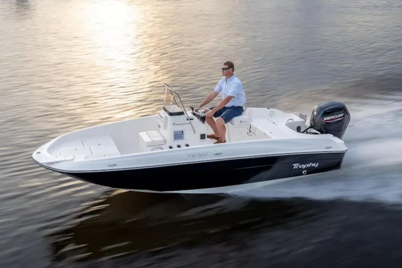 Slide: The Image of 2026 Bayliner Trophy T18 boat cruising on calm water at sunset. - 3