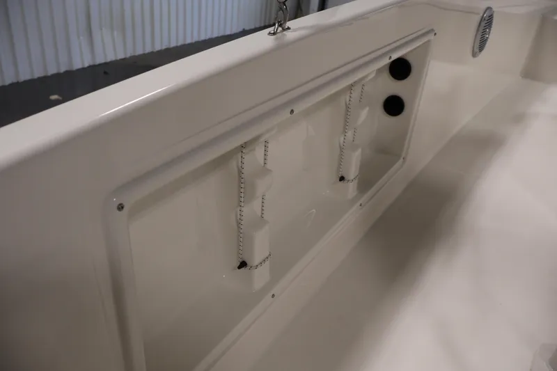 Slide: The Image of 2026 Bayliner Trophy T18 boat interior detail with storage compartment and speaker. - 34