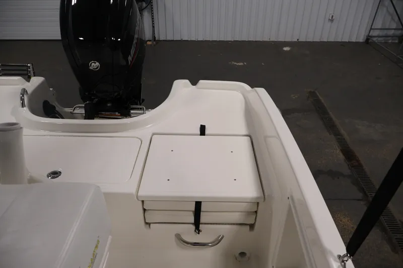 Slide: The Image of 2026 Bayliner Trophy T18 boat interior with Mercury engine, featuring storage compartment. - 35
