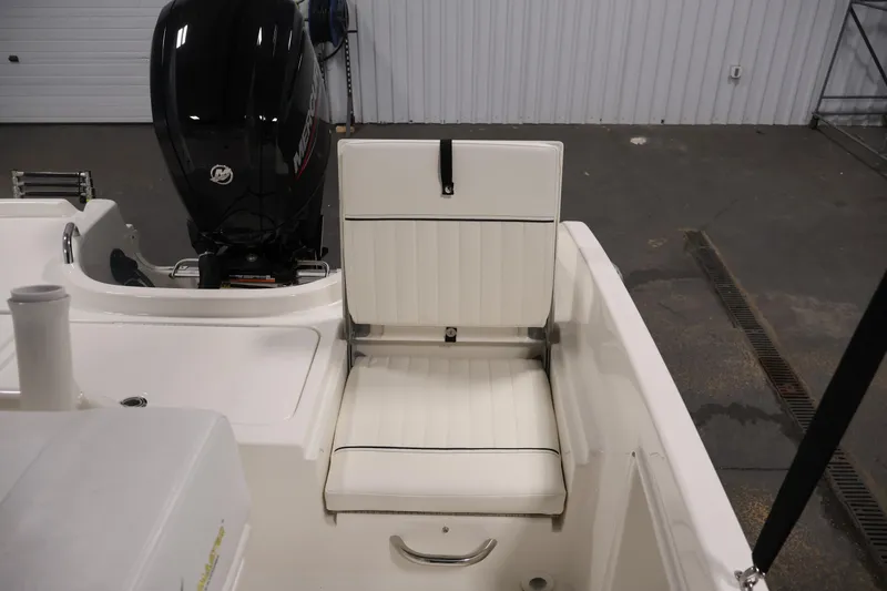 Slide: The Image of 2026 Bayliner Trophy T18 boat interior with white seating and Mercury outboard motor. - 36