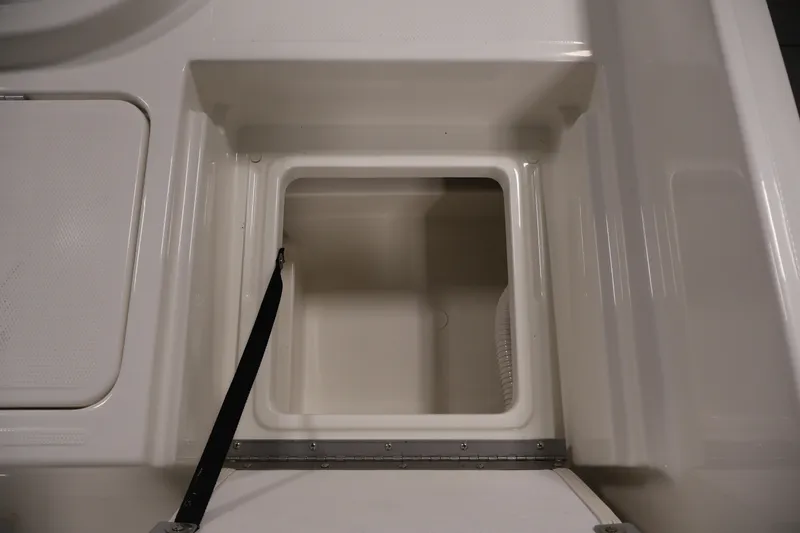 Slide: The Image of Storage compartment of 2026 Bayliner Trophy T18 boat, featuring a clean, white interior. - 37