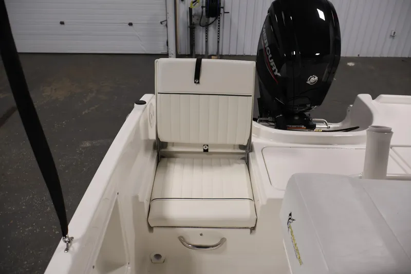 Slide: The Image of 2026 Bayliner Trophy T18 boat interior with white seating and Mercury outboard motor. - 39
