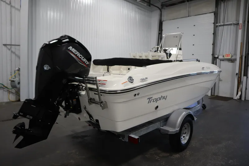 Slide: The Image of 2026 Bayliner Trophy T18 boat with Mercury engine on trailer in garage. - 4