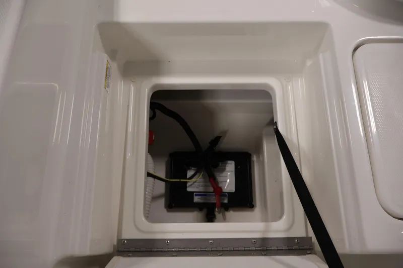 Slide: The Image of Battery compartment of 2026 Bayliner Trophy T18 boat, featuring secure wiring and storage. - 40