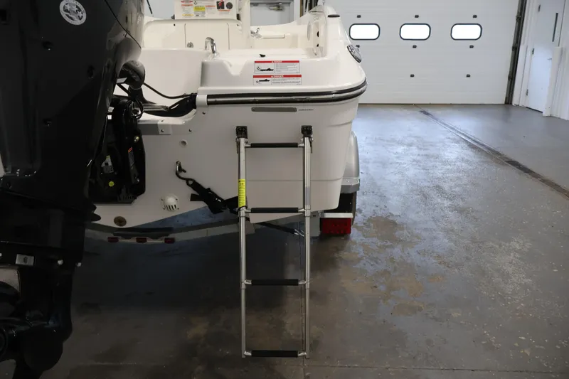 Slide: The Image of 2026 Bayliner Trophy T18 boat with ladder in a garage setting. - 42