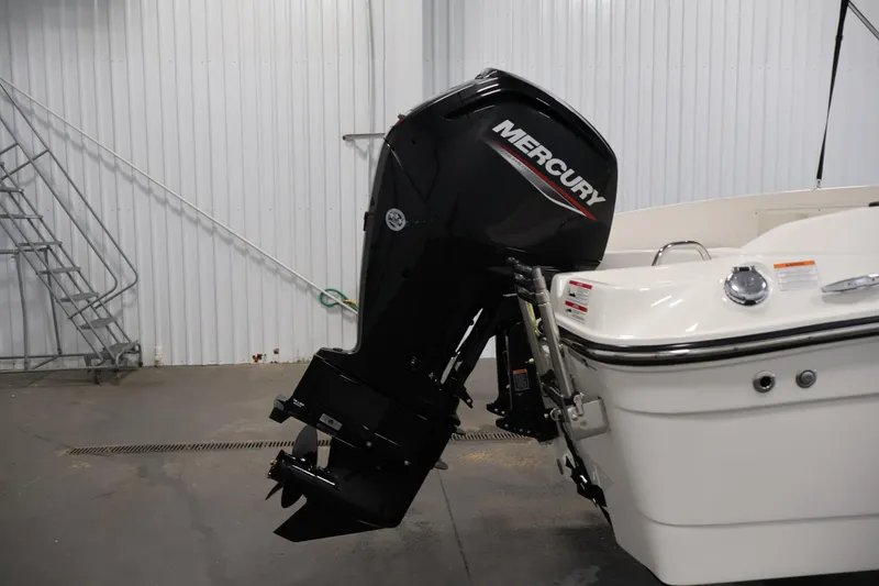 Slide: The Image of 2026 Bayliner Trophy T18 with Mercury outboard motor in a garage setting. - 44