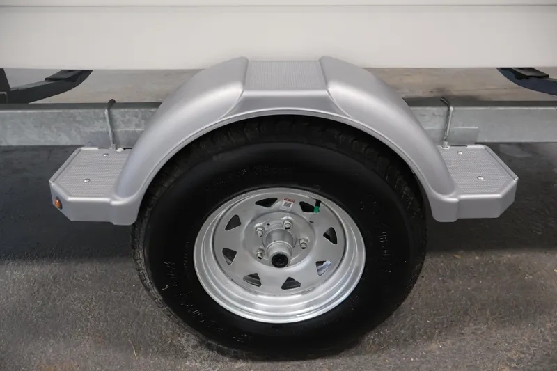Slide: The Image of Trailer wheel of 2026 Bayliner Trophy T18 boat, featuring a silver fender and step. - 48