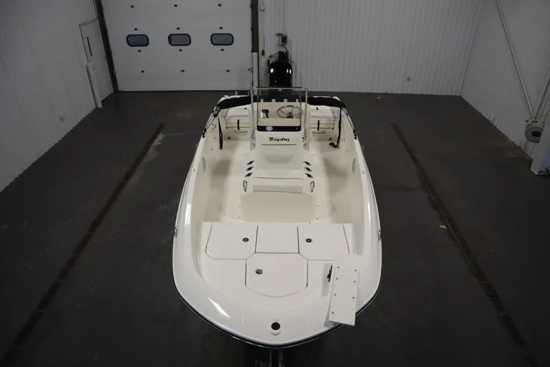 Slide: The Image of 2026 Bayliner Trophy T18 boat in a spacious indoor garage setting. - 8
