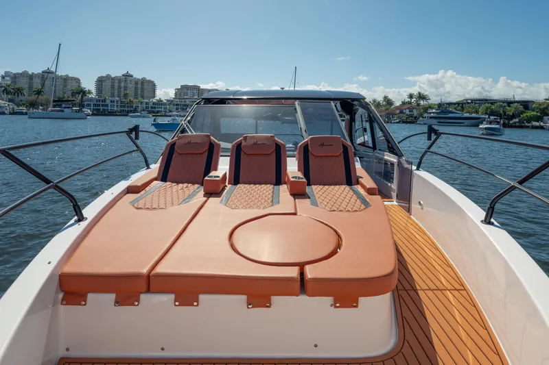 Slide: The Image of Luxurious 2026 Hanover 387 yacht with elegant seating, docked in a scenic marina. - 24