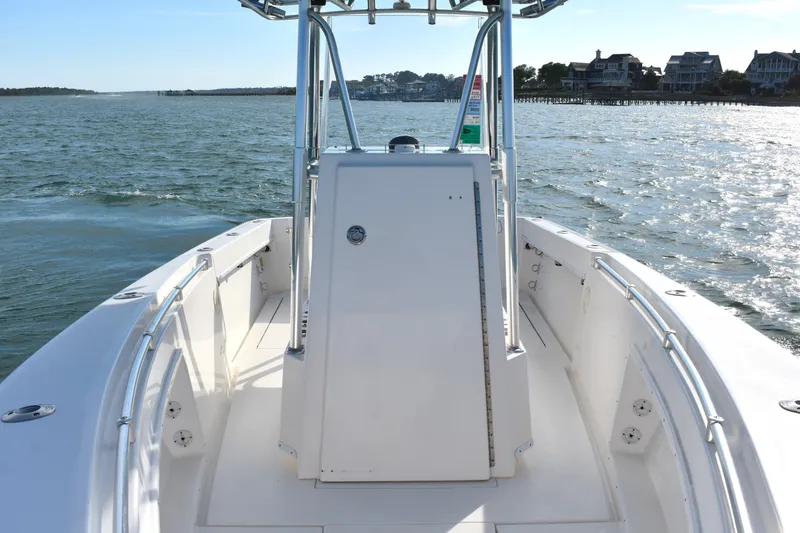 Slide: The Image of 2014 Contender 23 Open boat on water, clear day, coastal houses in background. - 11