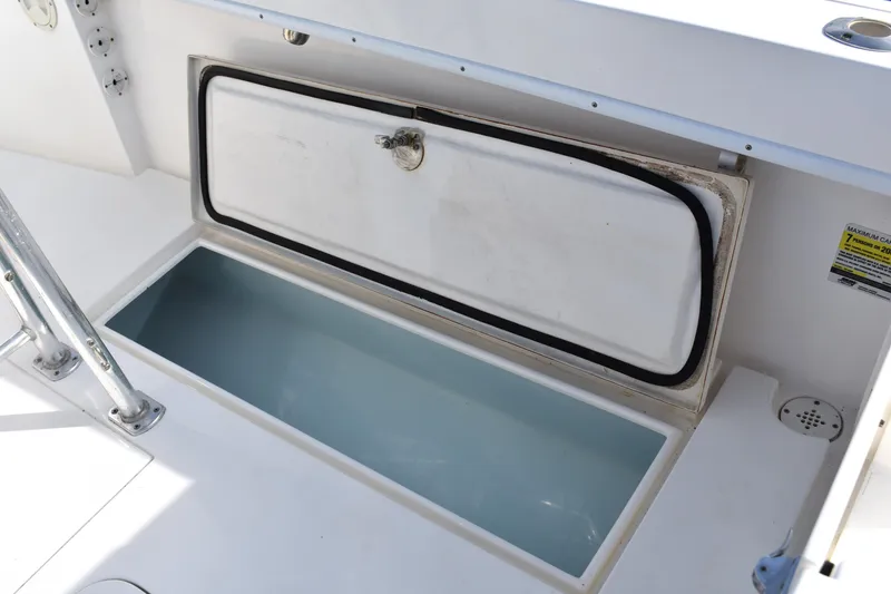 Slide: The Image of Open storage compartment on a 2014 Contender 23 Open boat. - 12