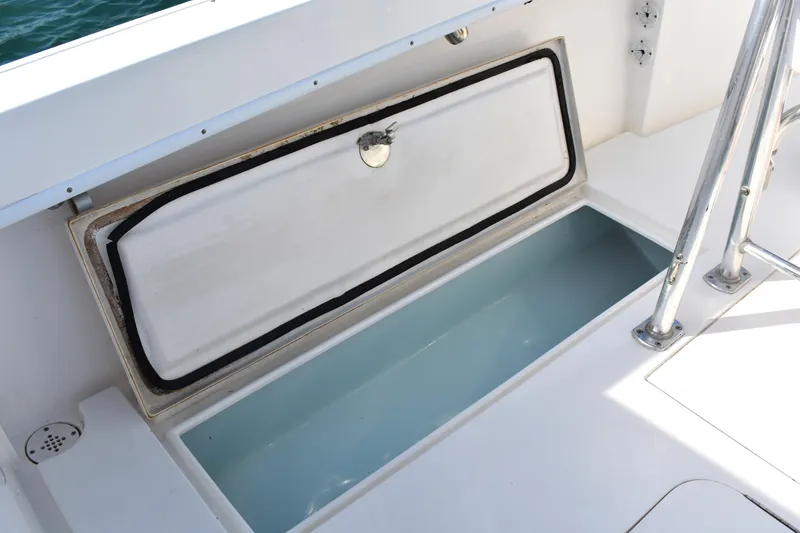 Slide: The Image of Open storage compartment on a 2014 Contender 23 Open boat deck. - 13