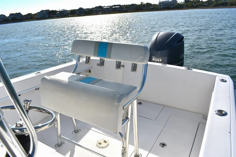Slide: The Image of 2014 Contender 23 Open boat with seating and Yamaha 300 engine on calm water. - 16