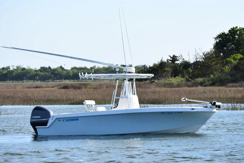 Slide: The Image of 2014 Contender 23 Open boat on water, Yamaha engine, scenic background. - 3