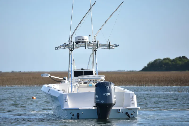 Slide: The Image of 2014 Contender 23 Open boat with Yamaha 300 engine on calm water. - 4