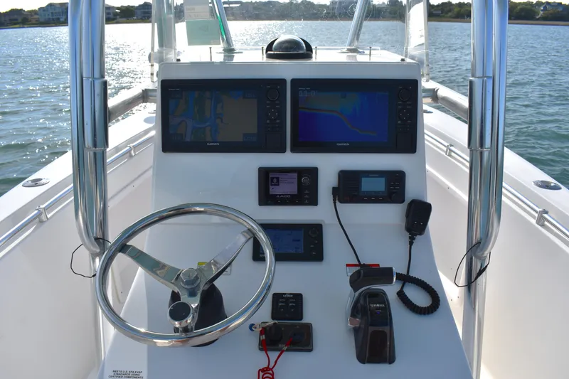 Slide: The Image of 2014 Contender 23 Open boat console with navigation screens and steering wheel. - 6