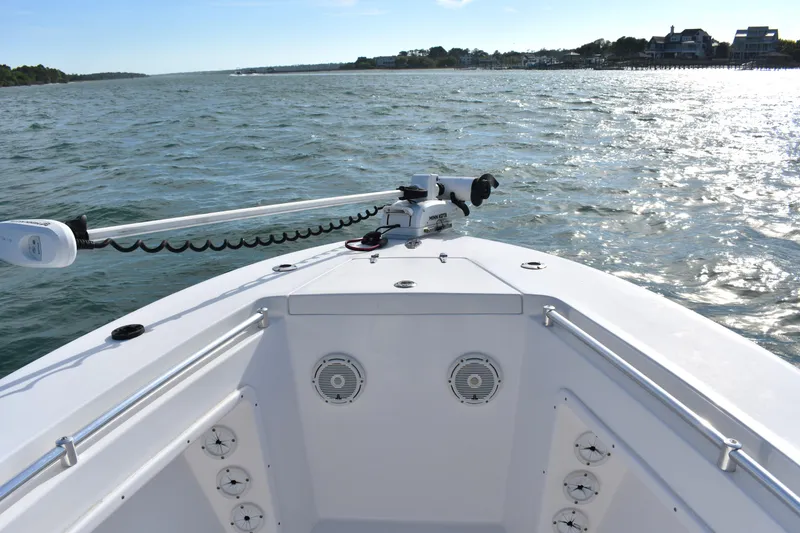 Slide: The Image of 2014 Contender 23 Open boat on water, showcasing bow and trolling motor. - 8