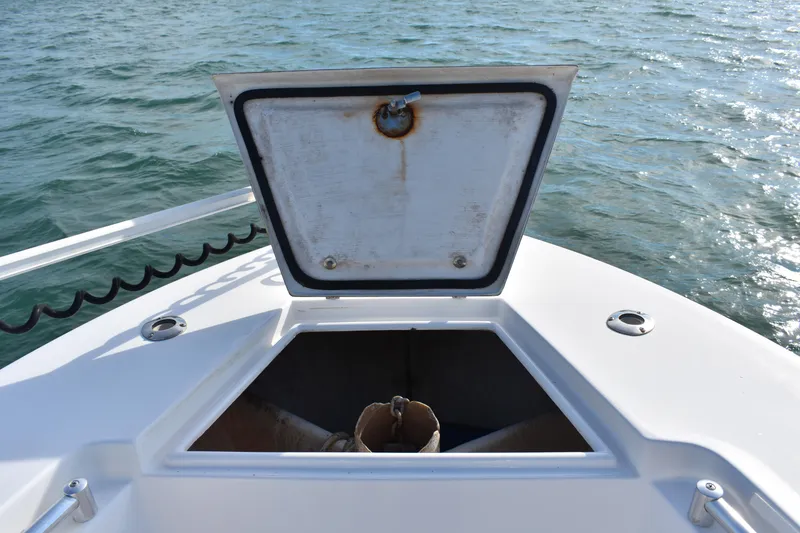 Slide: The Image of Open anchor hatch on 2014 Contender 23 Open boat, with ocean background. - 9