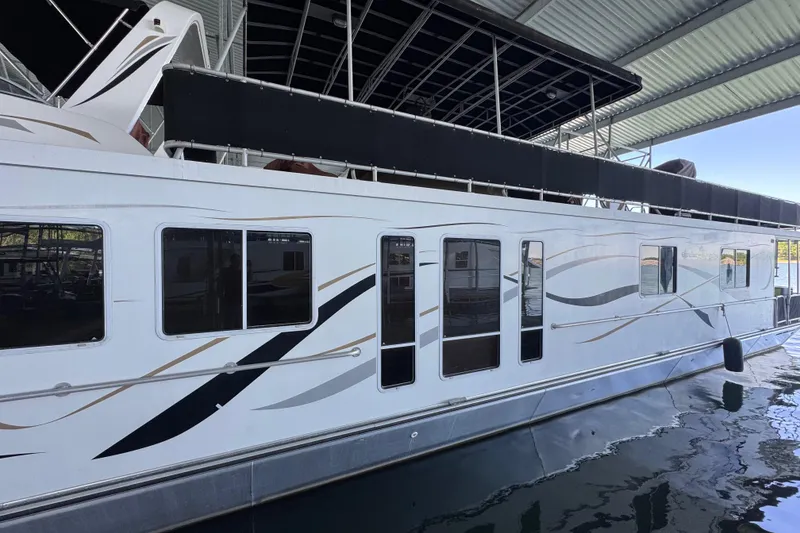 Slide: The Image of 2004 Starlite 65x16 houseboat docked under a covered marina. - 14