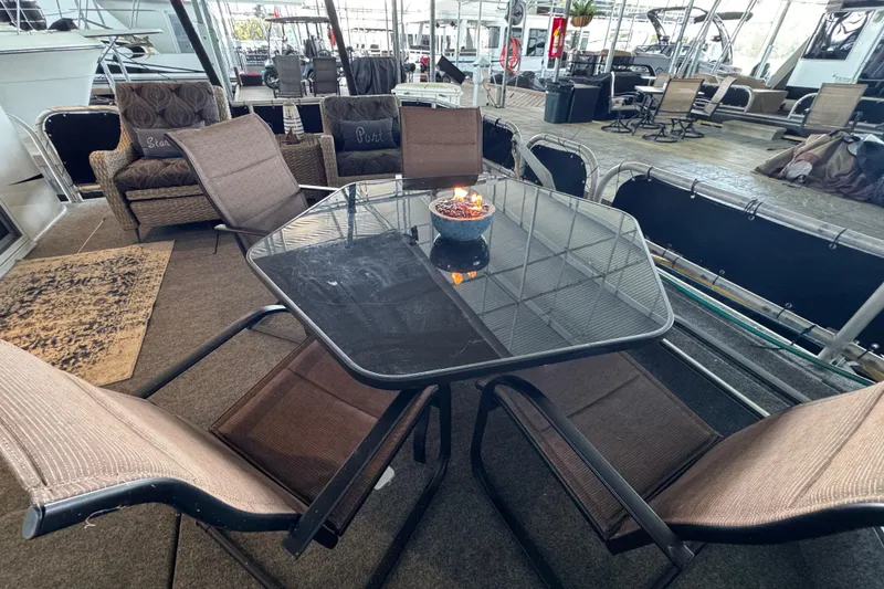 Slide: The Image of Outdoor seating area on a 2004 Starlite 65x16 houseboat with glass table and chairs. - 20