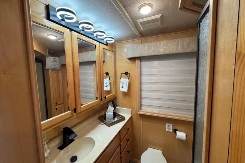 Slide: The Image of Modern bathroom in 2004 Starlite 65x16, featuring wood cabinetry and stylish lighting. - 53