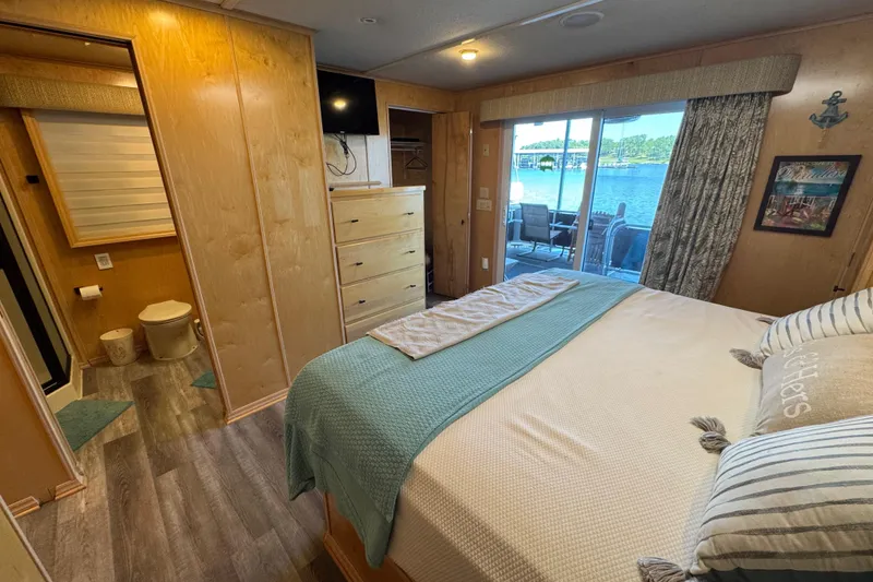 Slide: The Image of Bedroom interior of 2004 Starlite 65x16 houseboat with lake view and modern amenities. - 59