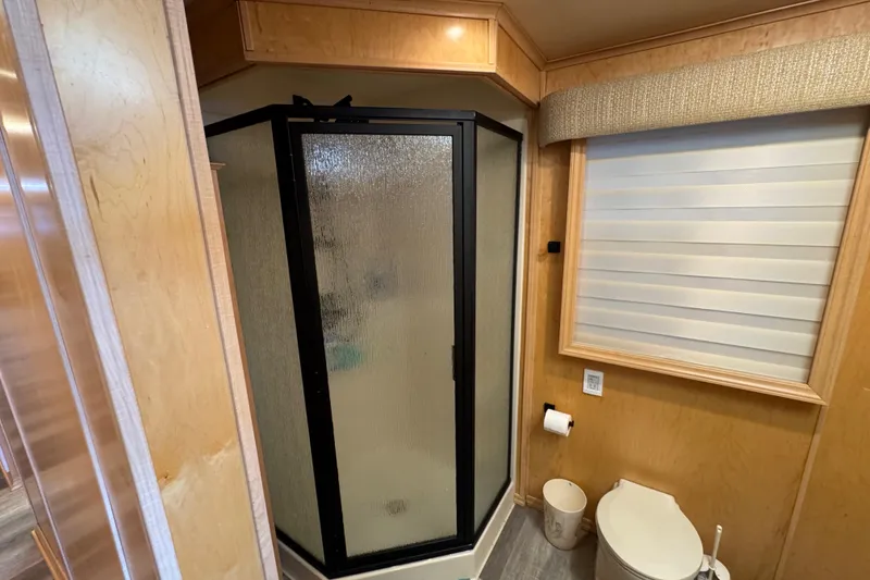 Slide: The Image of Compact bathroom in 2004 Starlite 65x16 with shower, toilet, and window shade. - 68
