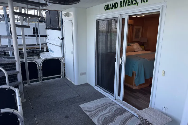 Slide: The Image of Houseboat interior with sliding glass door, spiral staircase, and cozy bedroom in Grand Rivers, KY. - 73