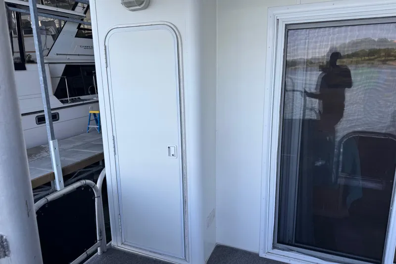 Slide: The Image of 2004 Starlite 65x16 boat interior with door and window reflection. - 75