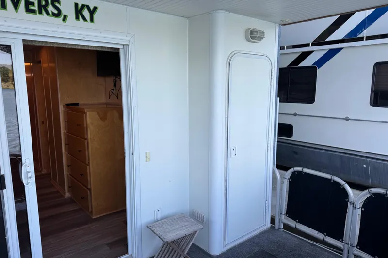 Slide: The Image of Outdoor view of a 2004 Starlite 65x16 houseboat with sliding door and interior glimpse. - 76