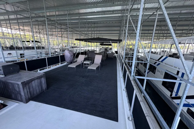 Slide: The Image of Covered marina with Starlite 65x16 houseboats, featuring outdoor seating, 2004 model. - 83