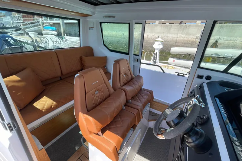 Slide: The Image of Interior of 2022 Axopar Brabus 28 Cabin with luxurious seating and steering wheel. - 32