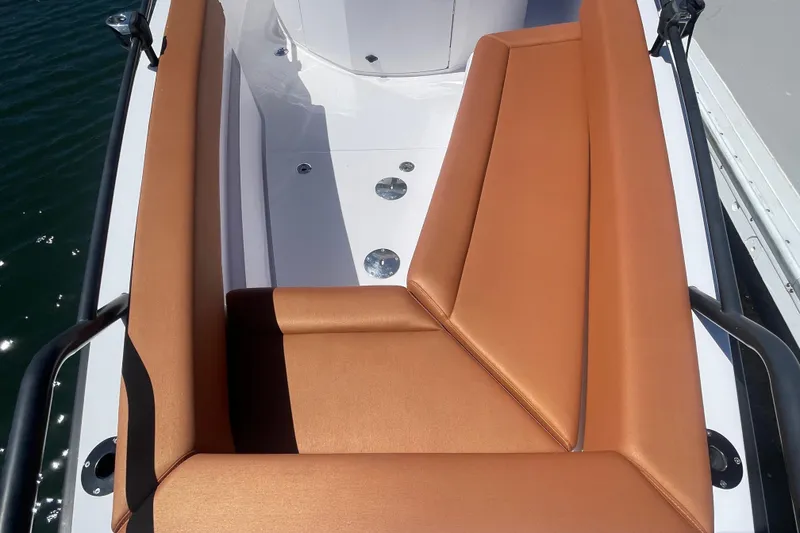 Slide: The Image of Luxurious seating on 2022 Axopar Brabus 28 Cabin boat with tan upholstery. - 10