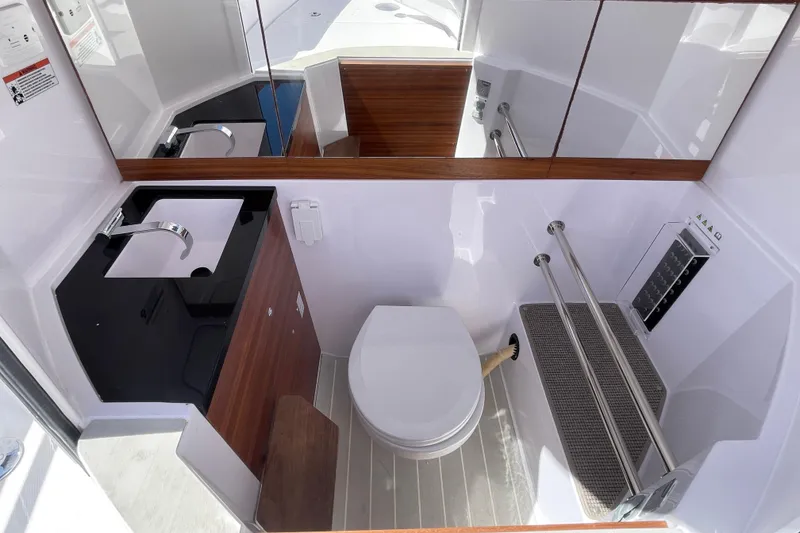 Slide: The Image of 2022 Axopar Brabus 28 Cabin bathroom with modern fixtures and sleek design. - 14