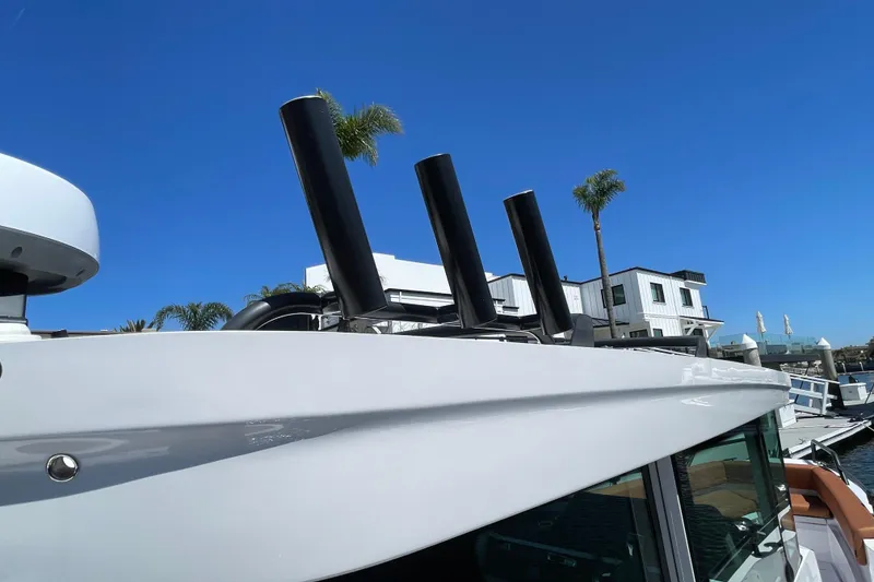 Slide: The Image of 2022 Axopar Brabus 28 Cabin boat with sleek design, docked under clear blue sky. - 16