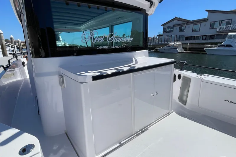 Slide: The Image of 2022 Axopar Brabus 28 Cabin boat docked, featuring sleek design and modern amenities. - 20