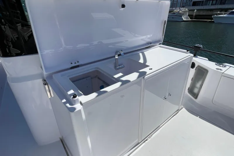 Slide: The Image of 2022 Axopar Brabus 28 Cabin boat sink and storage area on deck. - 21