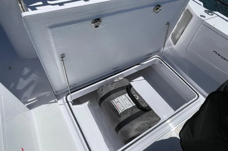 Slide: The Image of Storage compartment of 2022 Axopar Brabus 28 Cabin boat, featuring secure latch and spacious interior. - 25
