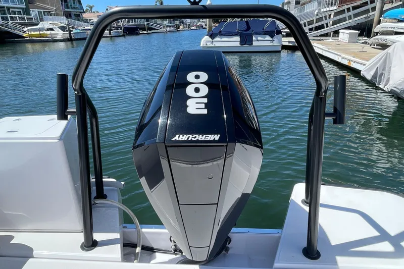 Slide: The Image of 2022 Axopar Brabus 28 Cabin with Mercury 300 engine in marina setting. - 26