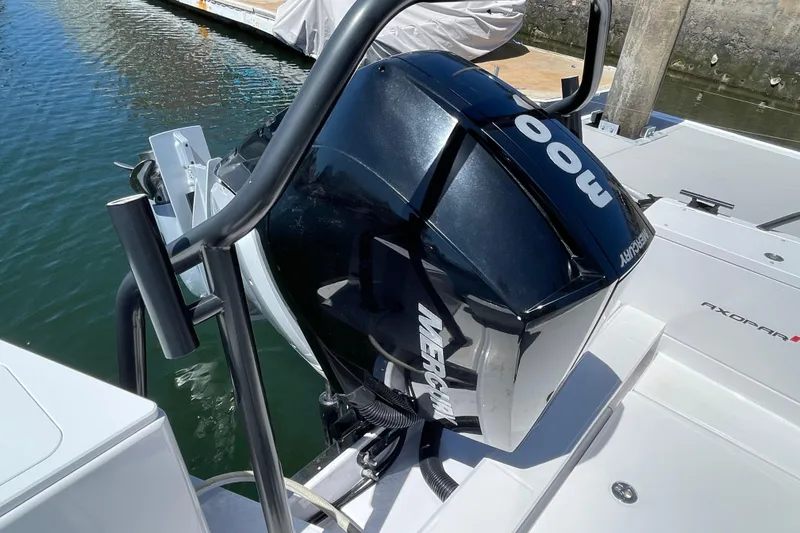 Slide: The Image of 2022 Axopar Brabus 28 Cabin with Mercury outboard engine, docked on calm water. - 27